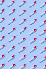 Image showing Health-care pattern of disposable syringes with red liquid.