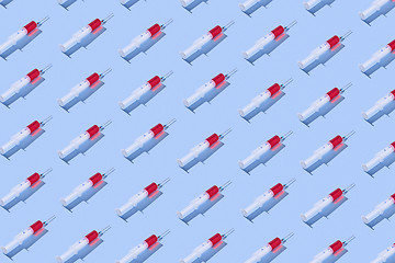 Image showing Medical pattern with plastic syringes of red vaccine.