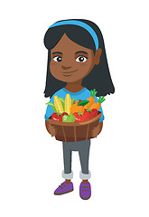 Image showing Girl holding basket with fruit and vegetables.