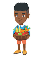 Image showing Boy holding basket with fruit and vegetables.