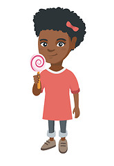 Image showing Little african girl holding a lollipop candy.