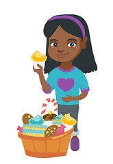 Image showing Girl holding a cupcake and stroking her belly.