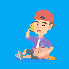 Image showing Business boy with a piggy bank and a cellphone.