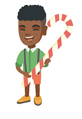 Image showing African little boy holding christmas candy cane.