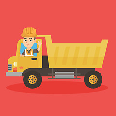 Image showing Little caucasian driver driving a dump truck.