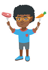 Image showing Little african boy holding fresh carrot and steak.
