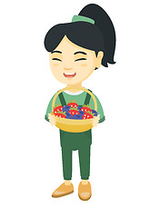 Image showing Girl with the basket of strawberry and blueberry.