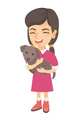 Image showing Caucasian happy girl holding a dog.