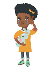 Image showing African-american girl crying and holding toy.