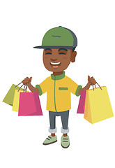 Image showing Happy african-american boy holding shopping bags.