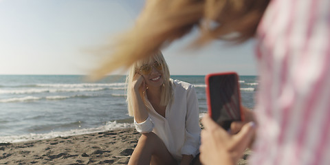 Image showing Two girl friends having fun photographing each other on vecation