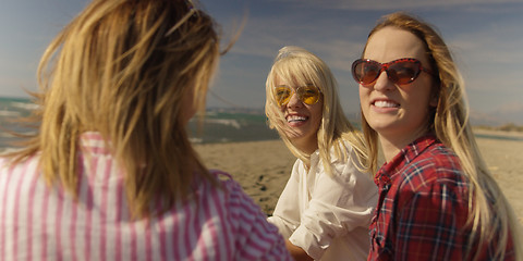 Image showing Group of girlfriends having fun on beach during autumn day