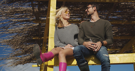 Image showing Couple drinking beer together at the beach