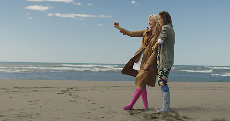 Image showing Girls having time and taking selfie on a beach