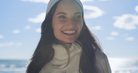 Image showing Girl In Autumn Clothes Smiling on beach