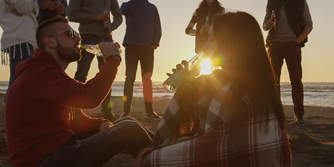 Image showing Friends having fun at beach on autumn day