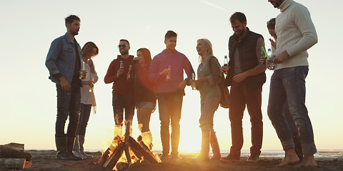 Image showing Friends having fun at beach on autumn day