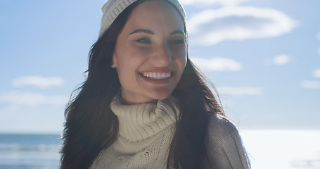 Image showing Girl In Autumn Clothes Smiling on beach