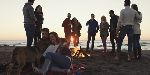 Image showing Friends having fun at beach on autumn day