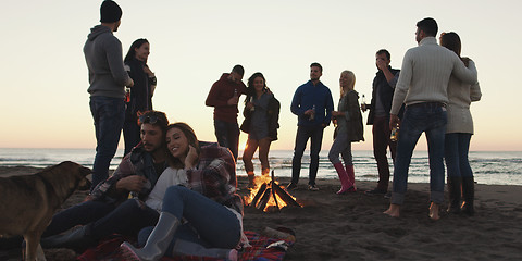 Image showing Friends having fun at beach on autumn day