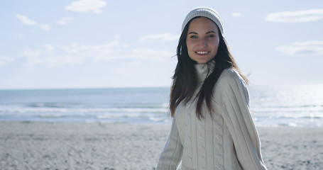 Image showing Girl In Autumn Clothes Smiling on beach