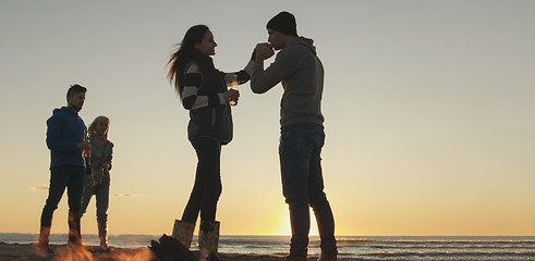 Image showing Friends having fun at beach on autumn day