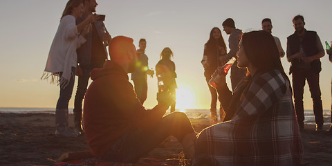 Image showing Friends having fun at beach on autumn day