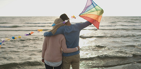 Image showing Happy couple having fun with kite on beach