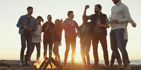 Image showing Friends having fun at beach on autumn day