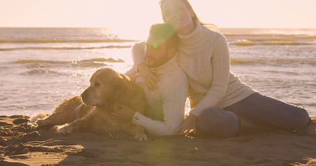 Image showing Couple with dog enjoying time on beach