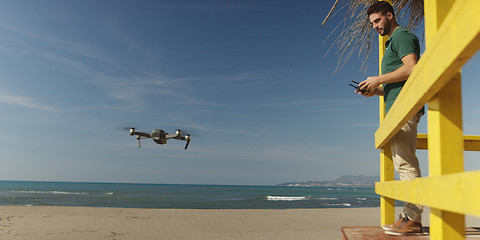 Image showing Man Operating Drone By The Sea