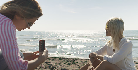 Image showing Two girl friends having fun photographing each other on vecation