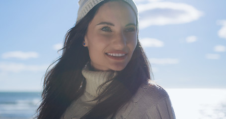 Image showing Girl In Autumn Clothes Smiling on beach