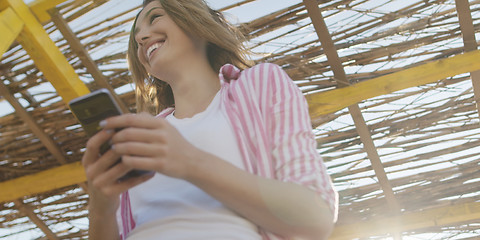 Image showing Smartphone Woman Texting On Cell Phone At Beach