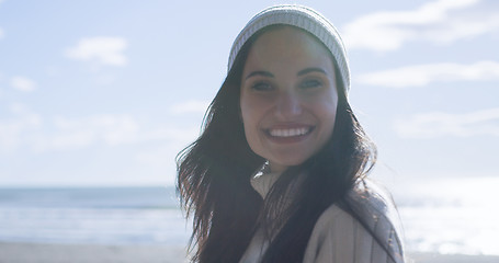 Image showing Girl In Autumn Clothes Smiling on beach