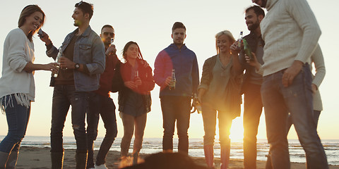 Image showing Friends having fun at beach on autumn day