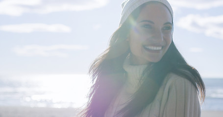 Image showing Girl In Autumn Clothes Smiling on beach