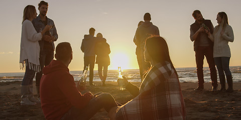 Image showing Friends having fun at beach on autumn day