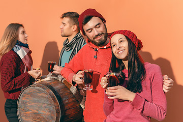 Image showing Smiling european men and women during party photoshoot.