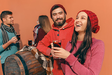 Image showing Smiling european men and women during party photoshoot.