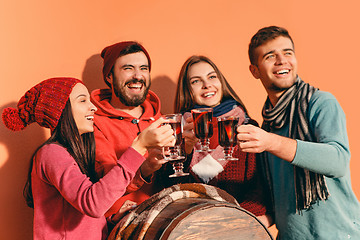 Image showing Smiling european men and women during party photoshoot.