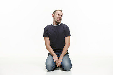 Image showing very disappointed man isolated on white background. studio shot