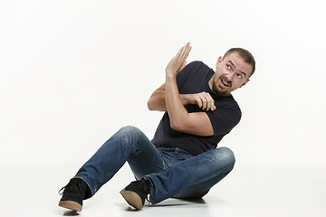 Image showing young cool man full body scared pose.
