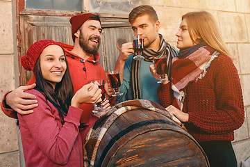 Image showing Smiling european men and women during party photoshoot.