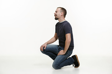 Image showing very disappointed man isolated on white background. studio shot