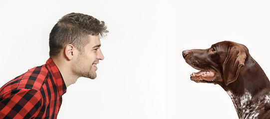 Image showing Emotional Portrait of a man and his dog, concept of friendship and care of man and animal