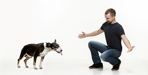 Image showing Emotional Portrait of a man and his shepherd dog, concept of friendship and care of man and animal