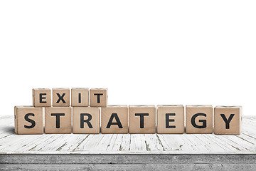 Image showing Exit strategy sign on a wooden desk