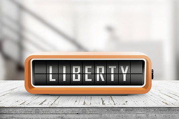 Image showing Liberty message on an orange alarm clock