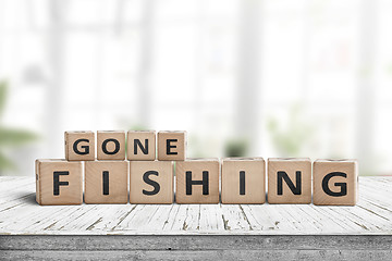 Image showing Gone fishing message in a living room